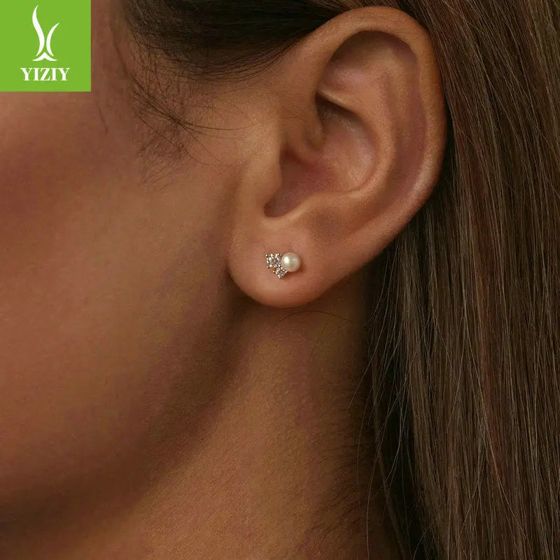 Close-up of a model wearing sparkling moissanite pearl cluster stud earrings