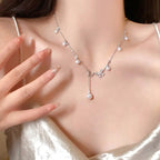 Silver-toned Y-drop necklace with spaced pearls and a crystal floral cluster