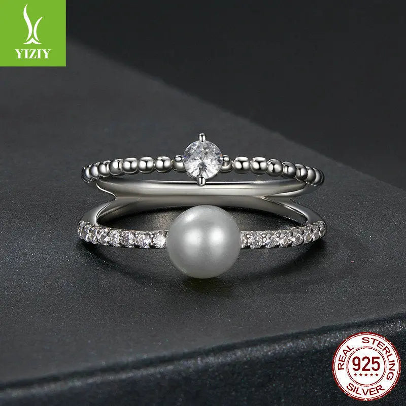 Close-up of S925 Sterling Silver Beaded Pearl and Moissanite Ring on Textured Dark Background