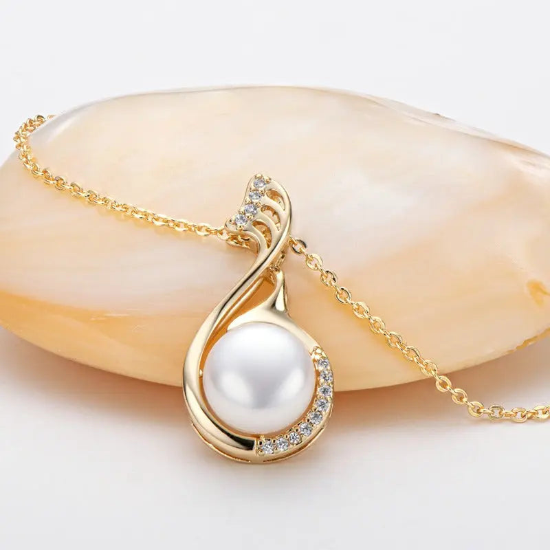 Gold Pearl Necklace Resting on a Beige Stone Backing