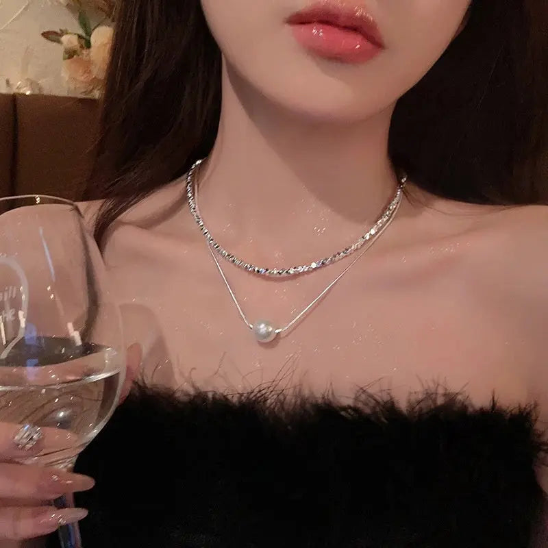 Layered silver-tone twisted metallic chain and pearl snake-style necklace