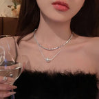 Layered silver-tone twisted metallic chain and pearl snake-style necklace