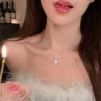 Delicate silver-toned chain necklace with a single small white pearl pendant