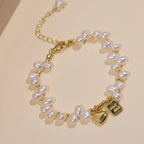 Double-strand freshwater pearl bracelet with a gold heart charm and tag