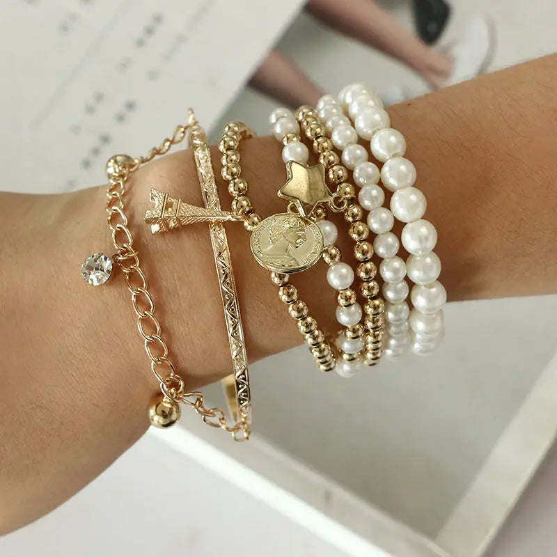 Vintage Gold Layered Pearl Charm Bracelet Stack - Six-Piece Set with Eiffel Tower and Coin Charms eprolo