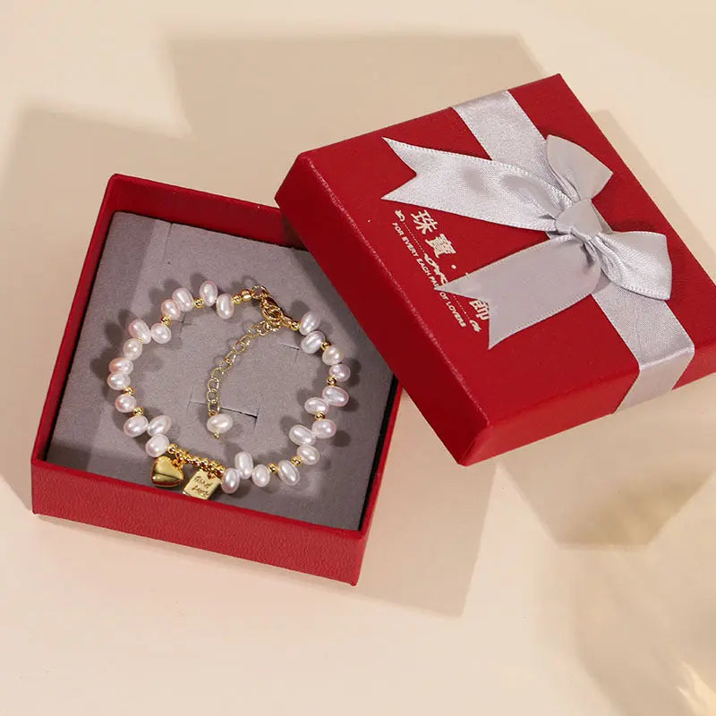 Freshwater pearl heart bracelet inside a premium red gift box with a ribbon
