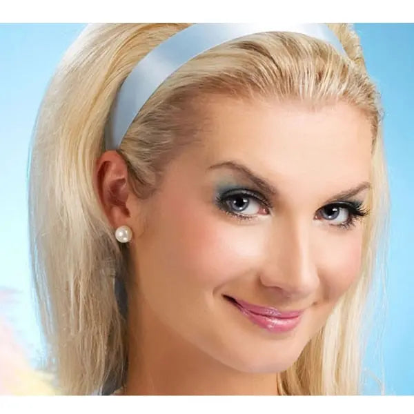 Model wearing classic white freshwater pearl stud earrings with a blue satin headband
