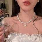 Dainty pearl choker with an opalescent cabochon stone pendant set in gold