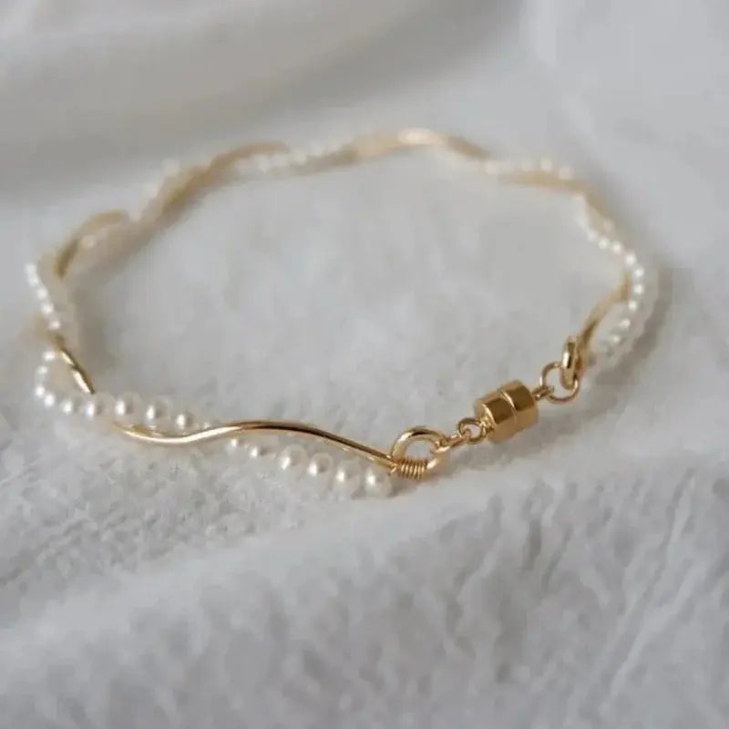 Studio-quality product photo of the gold wave adjustable freshwater pearl wrap bracelet