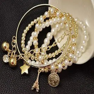 Vintage Gold Layered Pearl Charm Bracelet Stack - Six-Piece Set with Eiffel Tower and Coin Charms eprolo