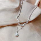 Silver layered faux pearl choker with pendant flat lay