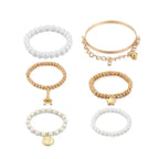 Vintage Gold Layered Pearl Charm Bracelet Stack - Six-Piece Set with Eiffel Tower and Coin Charms eprolo