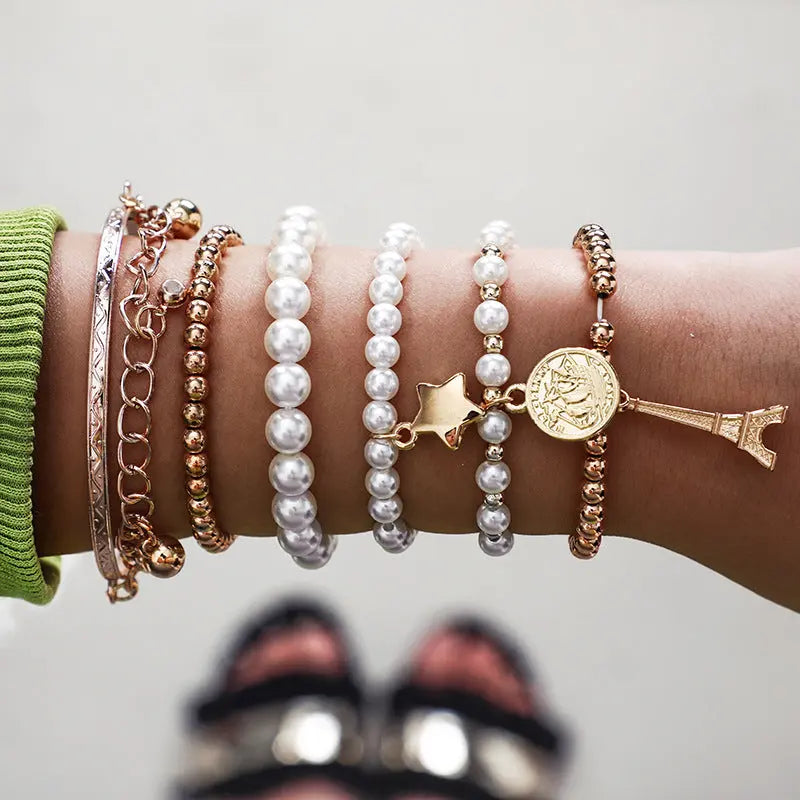 Vintage Gold Layered Pearl Charm Bracelet Stack - Six-Piece Set with Eiffel Tower and Coin Charms eprolo