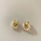 Double loop design natural freshwater pearl dangle earrings on off-white background