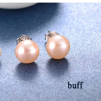 Lustrous peach freshwater pearl studs on silver posts with butterfly backs