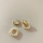 Detachable gold-plated huggie hoops and freshwater pearl charm set flat lay
