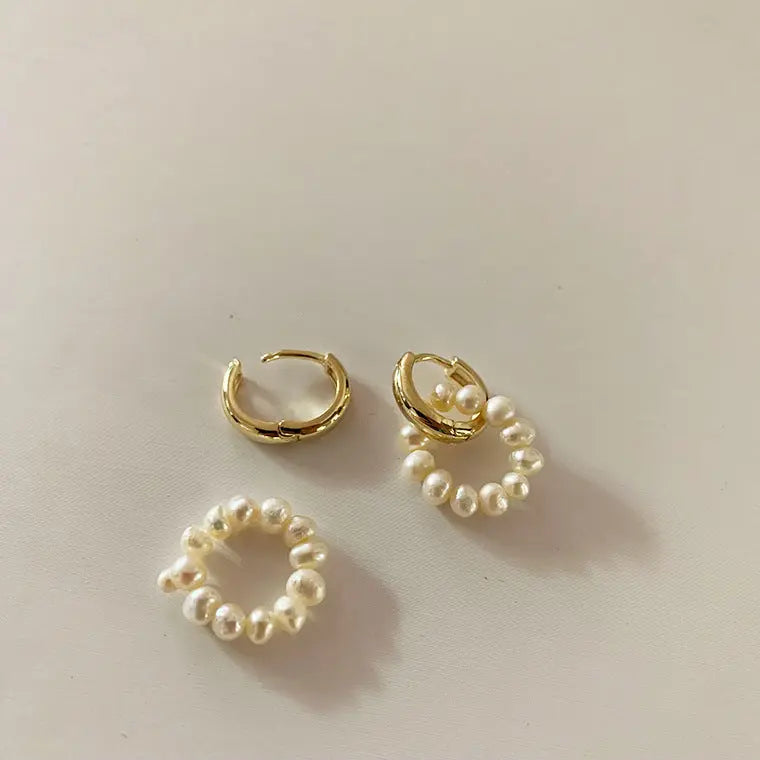 Detachable gold-plated huggie hoops and freshwater pearl charm set flat lay