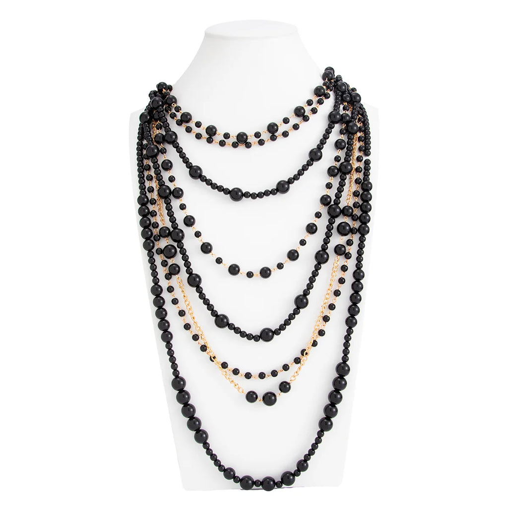 Pearl Layered Statement Body Chain in black and gold displayed on a white mannequin torso