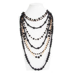 Pearl Layered Statement Body Chain in black and gold displayed on a white mannequin torso