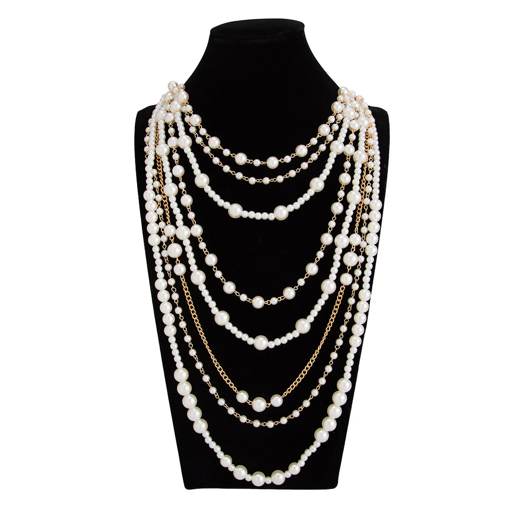 Pearl Layered Statement Body Chain with cream-white pearls displayed on a black velvet mannequin bust
