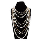Pearl Layered Statement Body Chain with cream-white pearls displayed on a black velvet mannequin bust