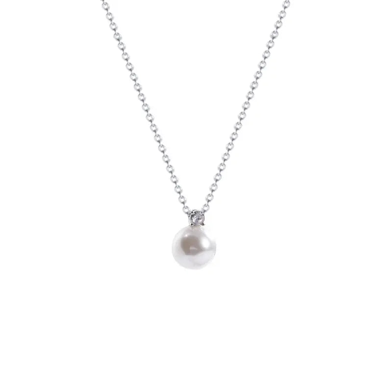 Silver chain necklace with a single white pearl and zircon pendant