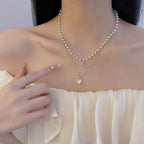 Layered gold-tone pearl choker and a gold link chain with a heart-shaped opal pendant