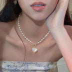 Pearl necklace with a heart-shaped opal-like pendant and gold toggle clasp