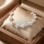 Elegant floral freshwater pearl bracelet on a seamless white background, flat lay studio shot