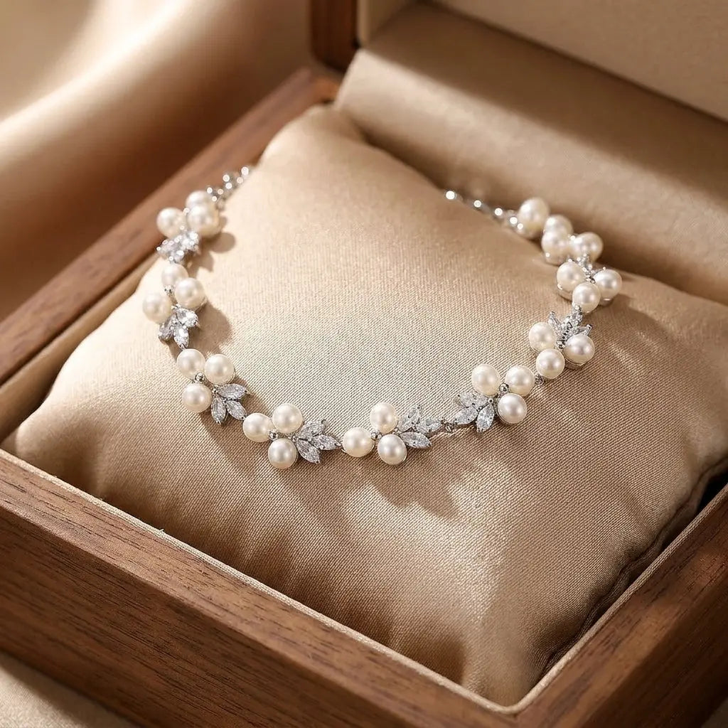 Elegant floral freshwater pearl bracelet on a seamless white background, flat lay studio shot