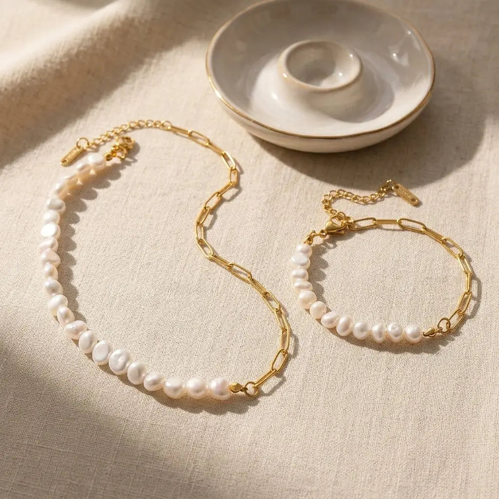 Freshwater pearl half chain necklace and bracelet set on beige linen cloth in warm sunlight