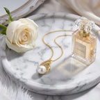 Premium lifestyle flat lay of Swan Pearl Necklace on marble vanity