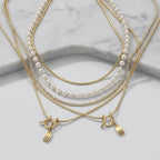 Layered Pearl Pendant Necklace on elegant marble studio background