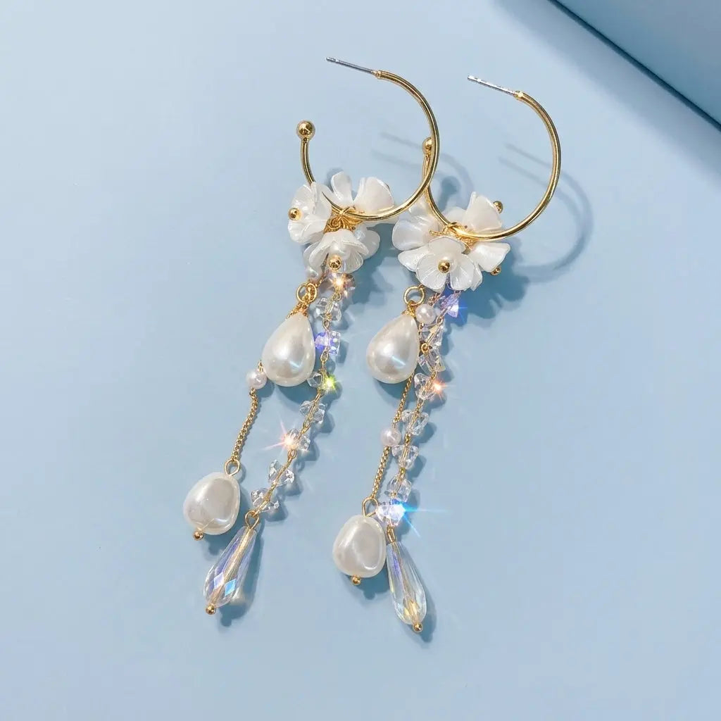 Style E0123 French Long Pearl Tassel Earring on a light blue studio background