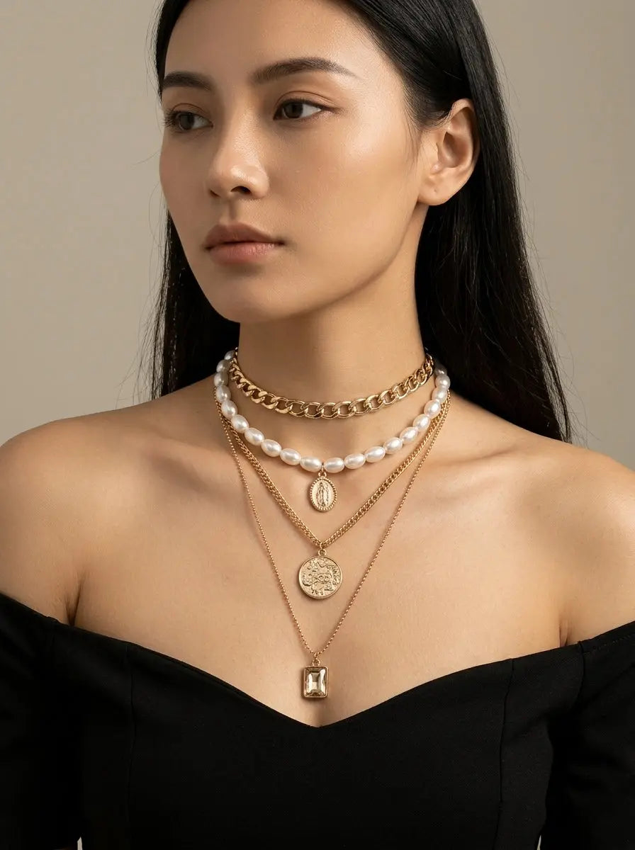 Chic model wearing Gold Layered Pearl Choker and Coin Pendant Necklace Set in elegant high fashion studio setting