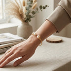 Elegant lifestyle shot of a woman wearing the handcrafted freshwater pearl wire-wrapped cuff bangle